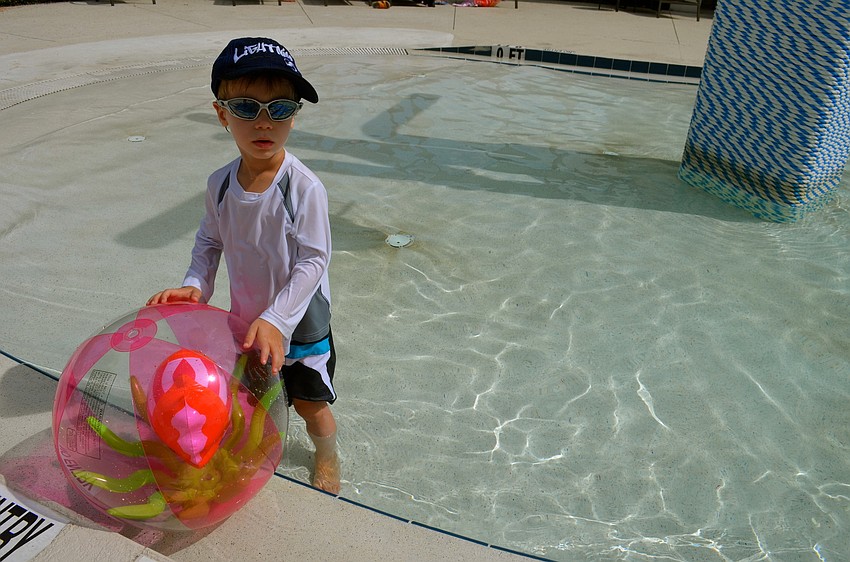 Three-year-old Ari Rahman sun bathes in the pool.