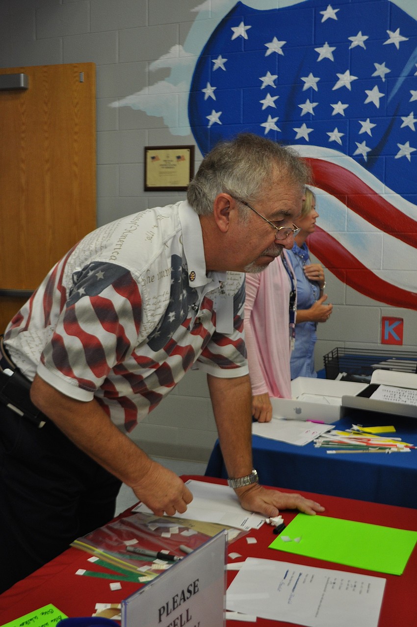 Founding principal, Gary Holbrook, helps with check-in.
