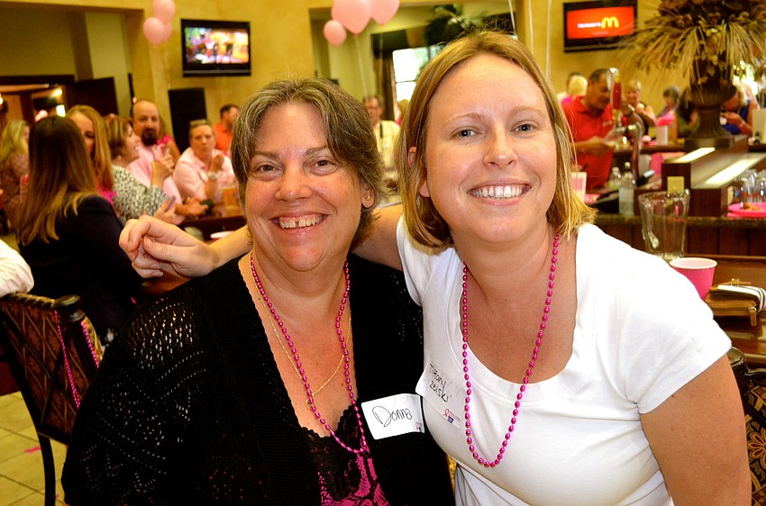 Donna Rhodes and Tiffany Zelski enjoy the event's food and beverages.