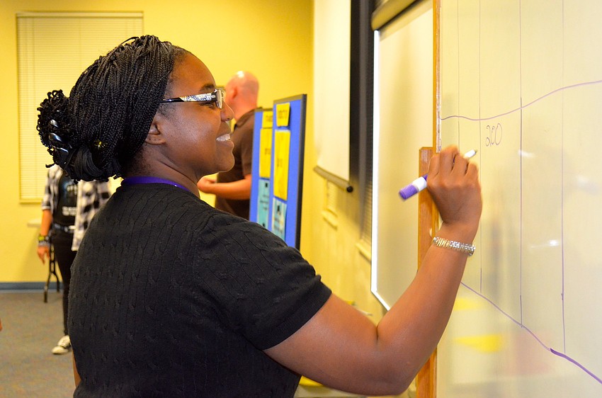 Renee Stokes plays scorekeeper during the trivia game.