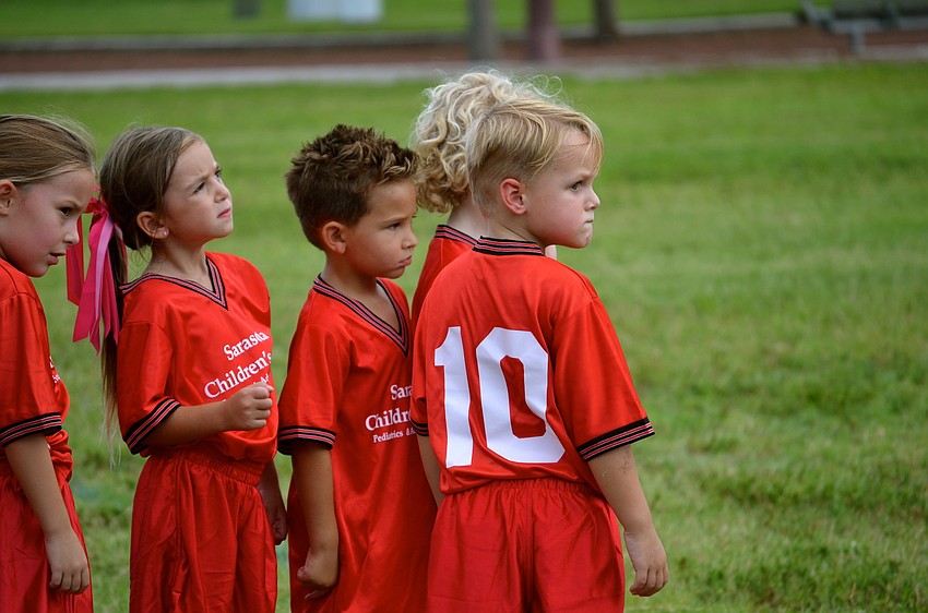 Angel Fish team members listen to their coach during practice.