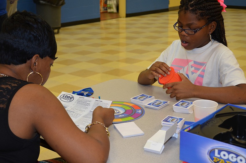 Cleshia Woodie and her daughter Janyla play Logo Party. This is their second year in attendance for the Family Fun Night.