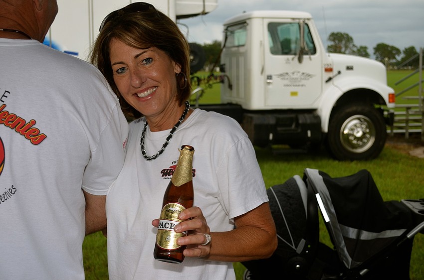 Tina Glanden enjoys a beer at her booth.