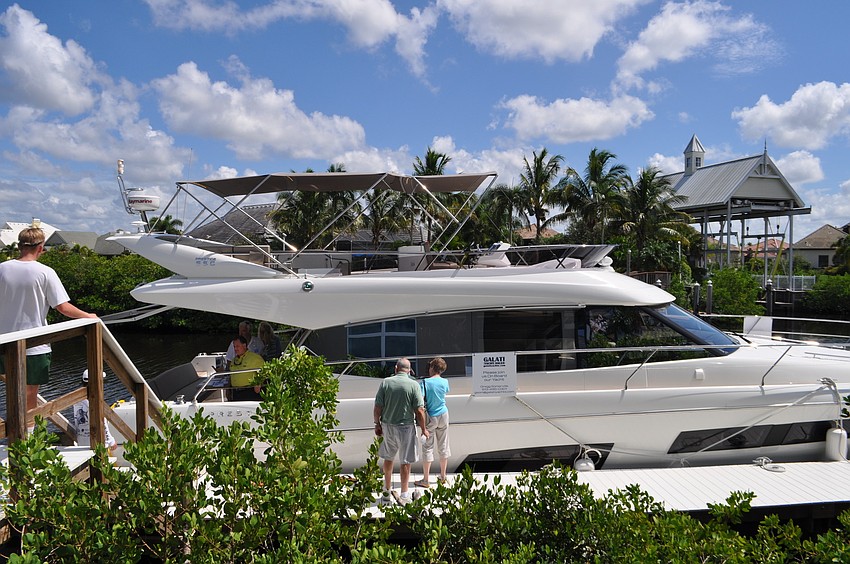 Guests view a yacht parked behind one of the featured homes.