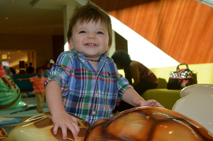 Beckham Buchanan plays in the children's play area.
