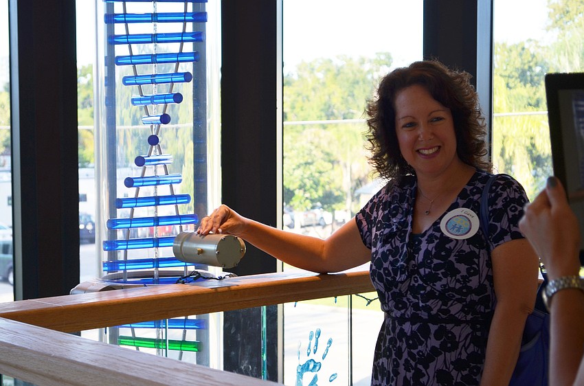 Jennifer Moss made a contribution to the Child Protection Center and dropped a marble into the Pillar of Hope to commemorate it.