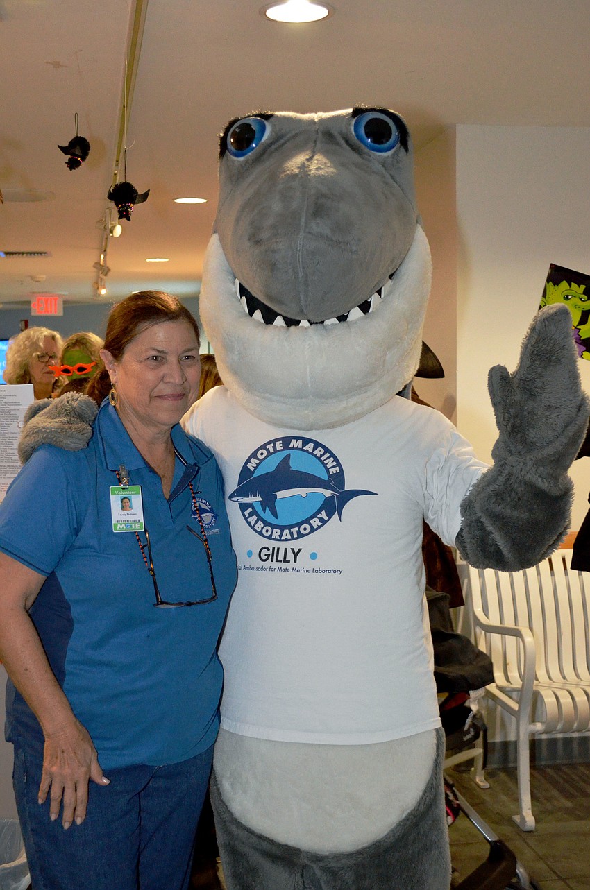 Mote volunteer Trudy Nelson poses with Gilly the Shark.
