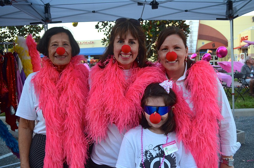 Jennifer Gemmeke, Patty Ordonez-Bains, Tonia Bichler and Olivia Bains show off pink products.