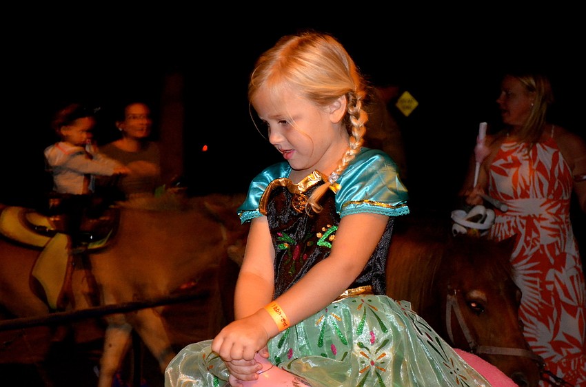 Jayden Hall rides a horse, Alabama, while her mother watches.