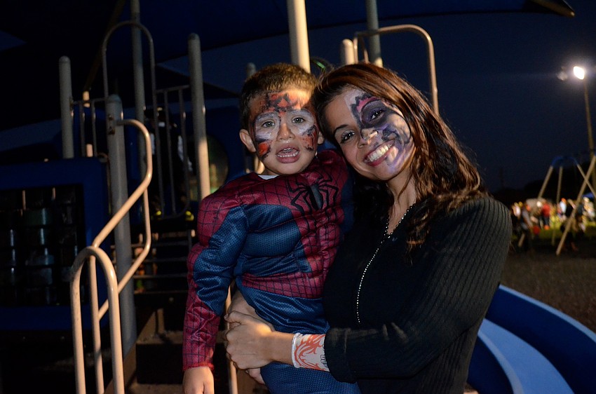 Dominic Betancourt and his mother, Claudia, wear smiles on their painted faces.