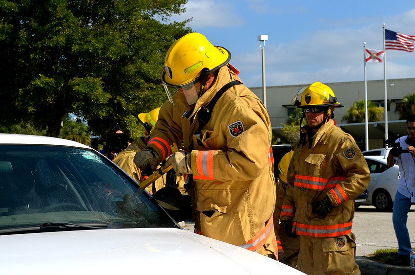 Chad Hoeksema cracks a windshield to show how to remove a trapped person from a vehicle.