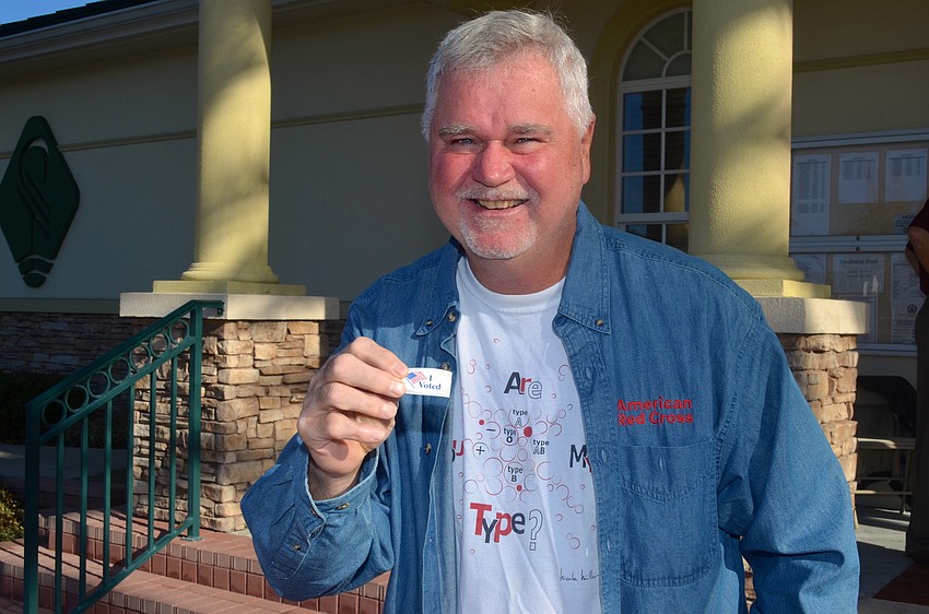 Dave Saunders votes an hour after the polls opened at Town Hall.