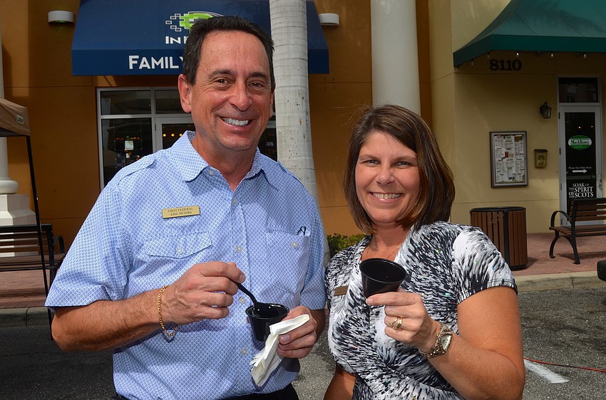 Colleagues Eric Peters and Tammy Zuknick make their rounds at different soup booths.
