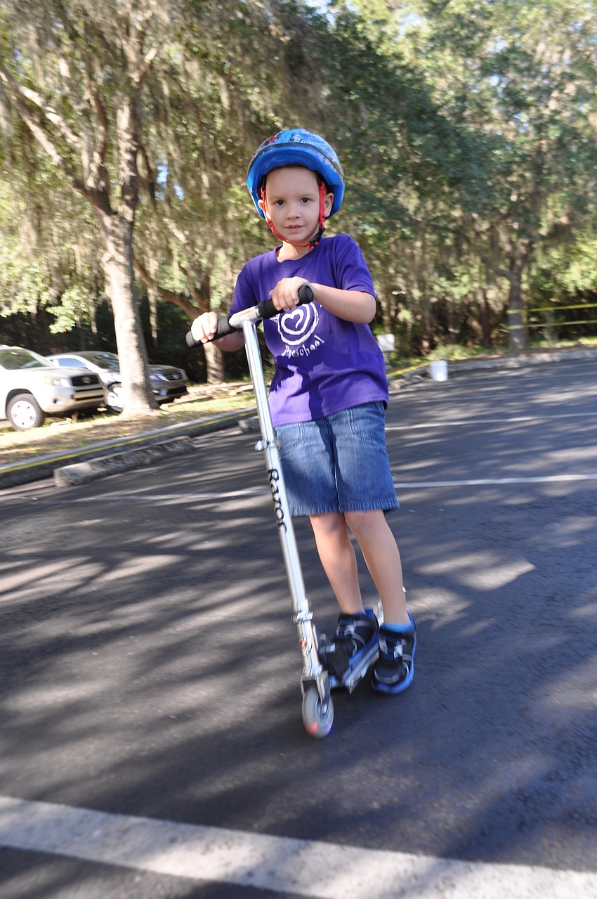 Reid Gilmore, 4, makes scooting look easy.