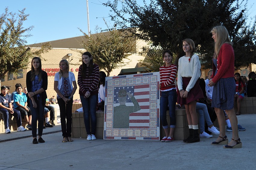 Taylor Lafave, Kara Claussen, Audri Cristello, Nicole Rios, Courtney Gape and teacher Heidi Enneking unveil the schoolâ€™s newest patriotic tile mosaic, which was designed by Nicole Rios.