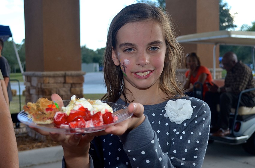 Brooke Miller covers her plate with sweet treats.