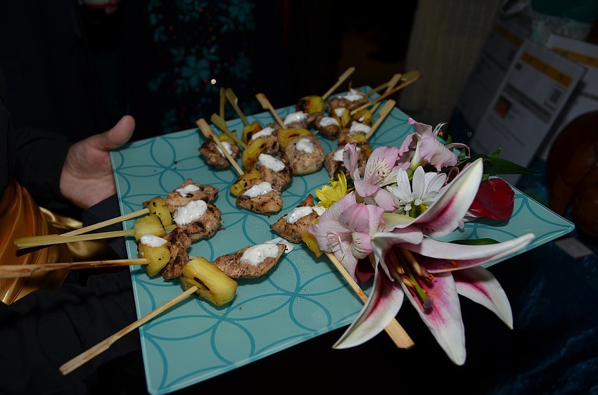 Skewers of jerk chicken with pineapple and a cilantro sauce.