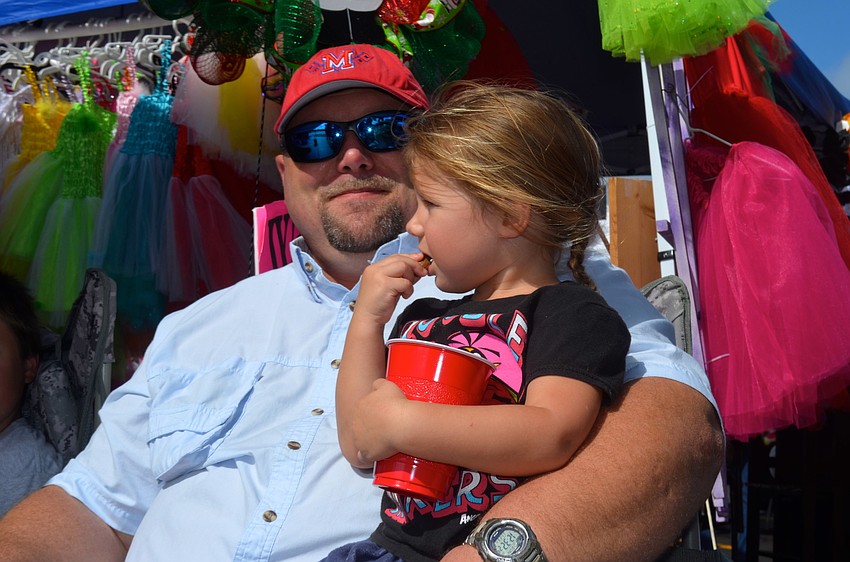 Jake Blanton and his daughter, Lily, relax in the shade.