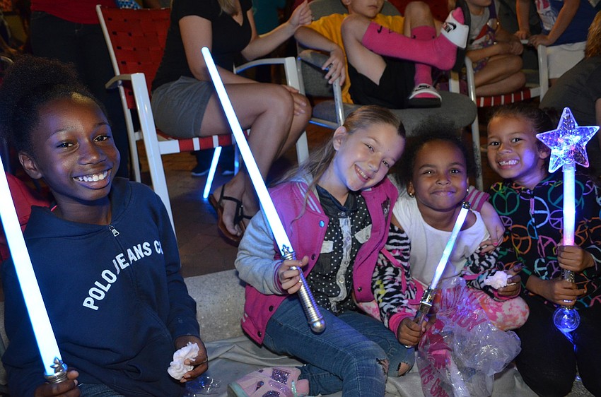 Samara Lee, Myah Aguilar, Chloe Truewell and Laylah Aguilar show off their light-up toys as they wait for the parade to start.