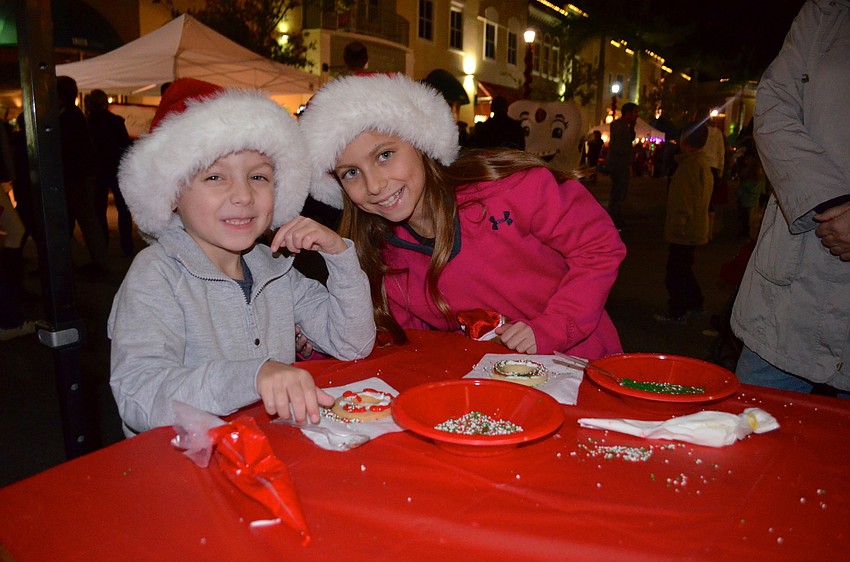 Tristan and Rafaela Larson decorate sweet holiday treats.