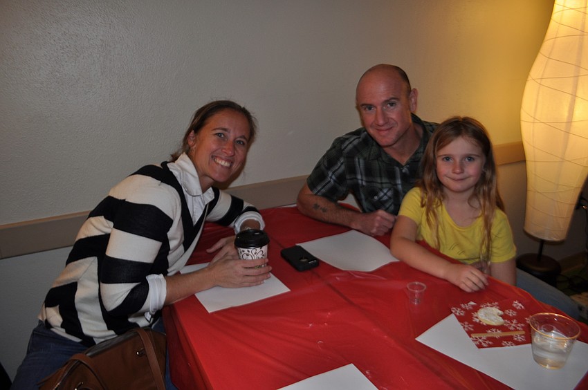 Kimberly and Corey Griffin watch their daughter, Madeline, eat dessert.