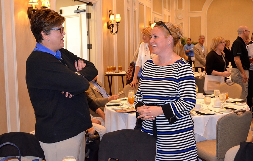 Chris Purnell and Nicole Rissler share stories before lunch.