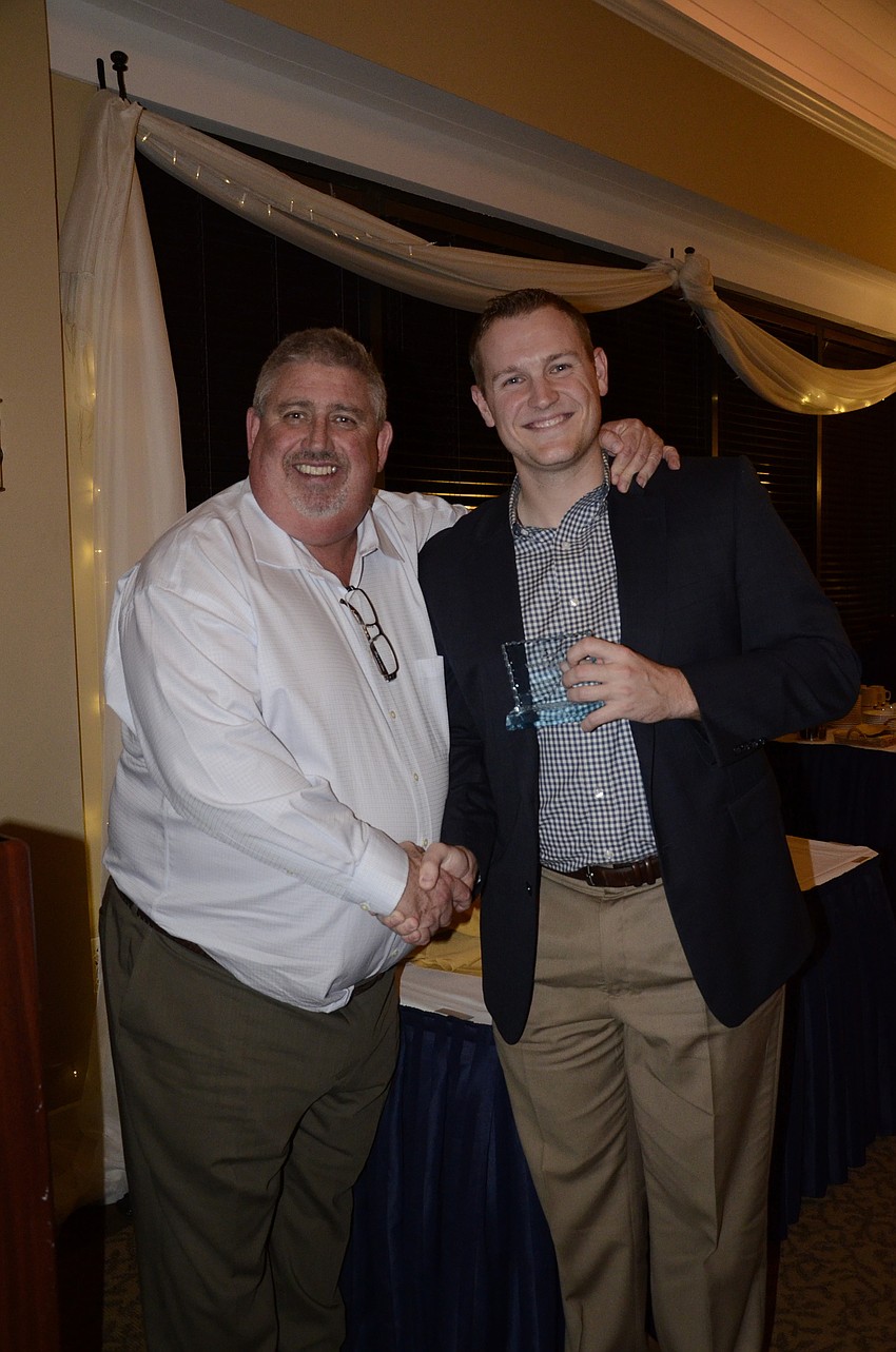 Dave Magee presents Regan Teague with the Volunteer Award.