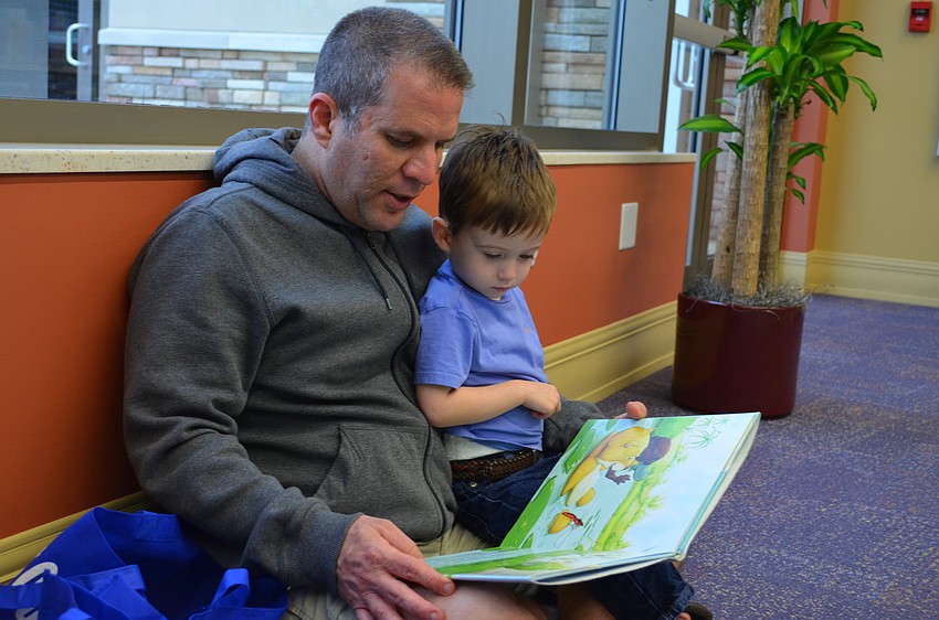 Tom Silverstein reads â€œSwim, Little Wombat Swimâ€ to his son Bennett.