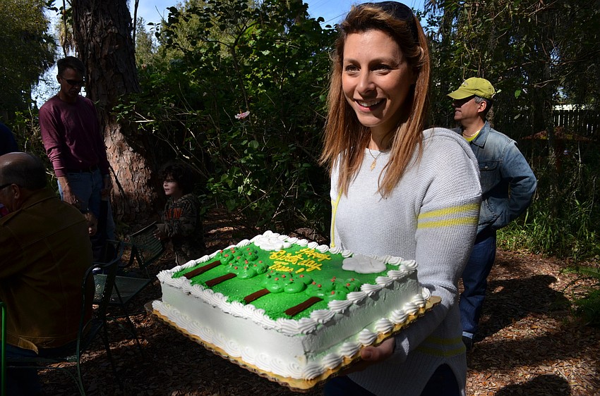 Alicia Zoller with a cake to celebrate the occasion.