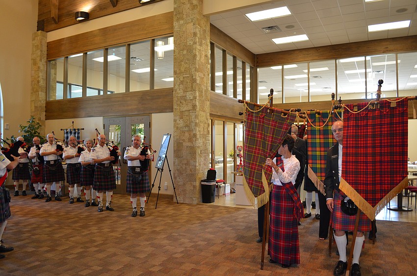 Congregation members and the pipe band prepare to begin the service.
