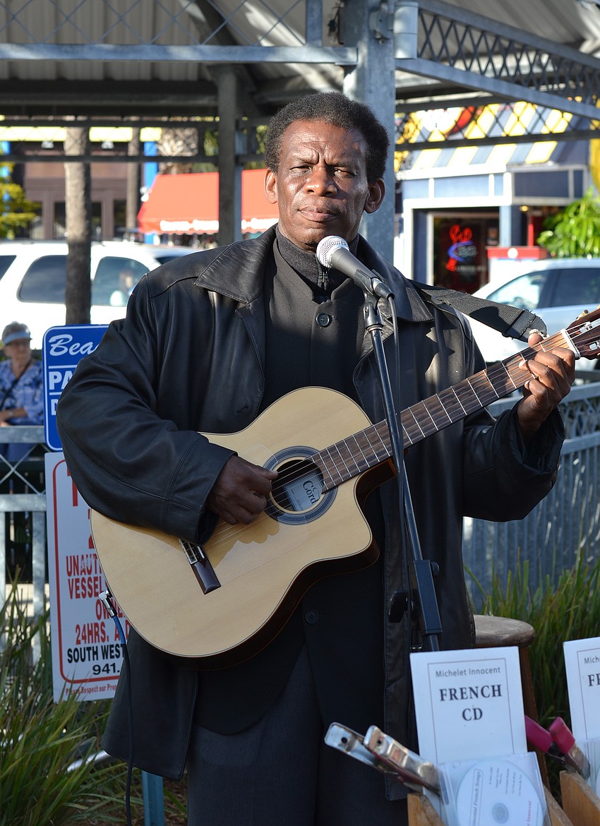 Michelet Innocent performed in French among the vendors for the craft festival.