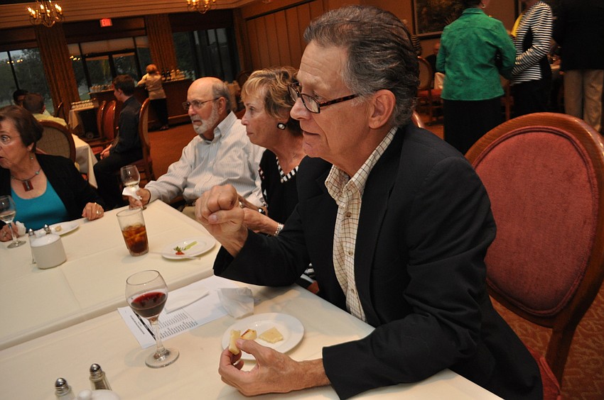 Malcolm Thornton chats with friends over appetizers.