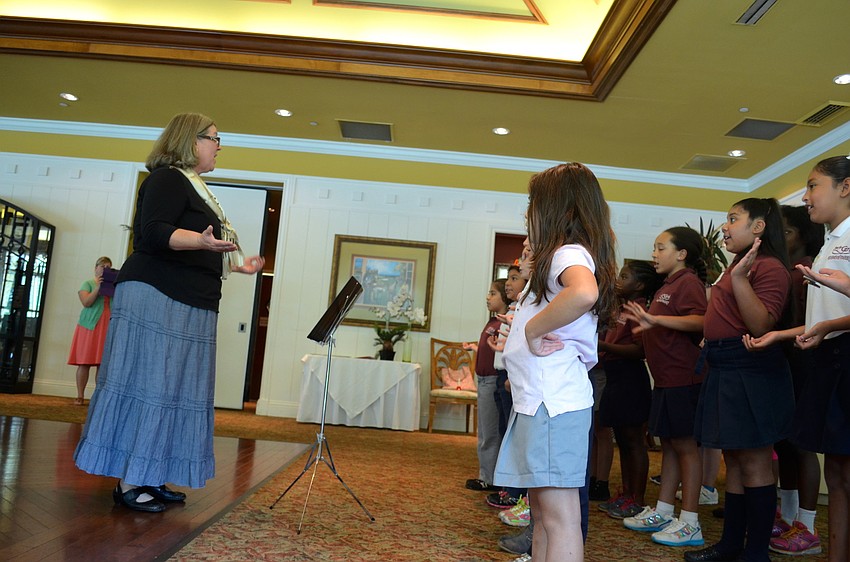 Just for Girls Academy music teacher Alicia Kennedy leads her students in song.
