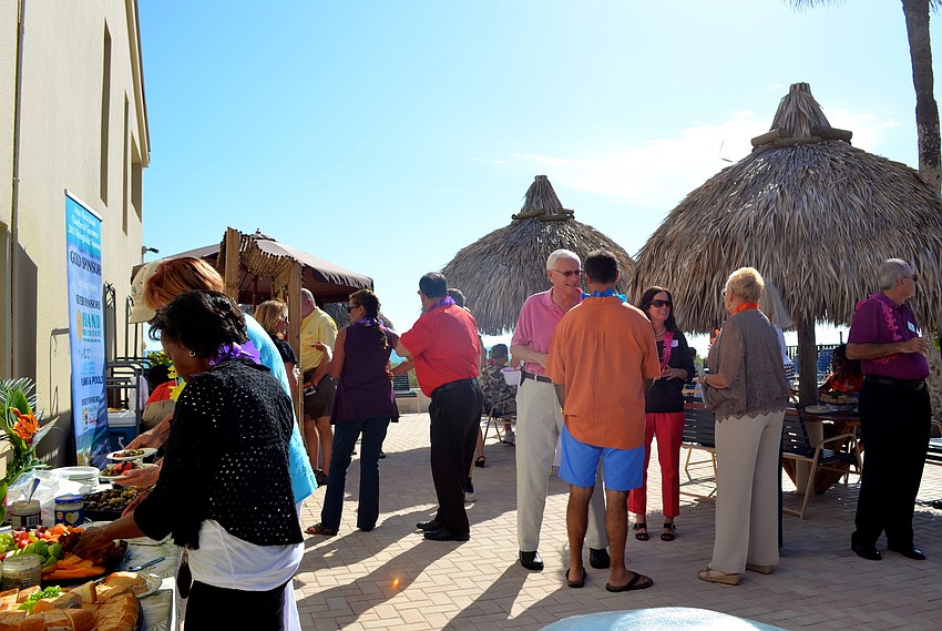 Attendees enjoy drinks, hors dâ€™oeuvres and the sun during the card swap at Casa Del Mar.