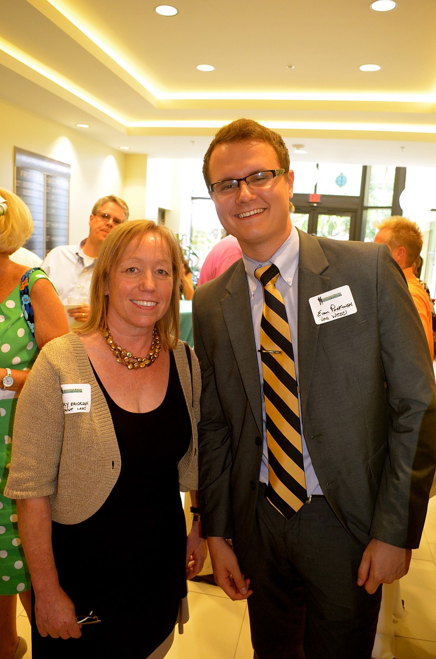 Nancy Erickson and Evan Pazkowski wait for the ribbon cutting.