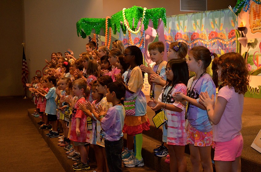 Vacation Bible School participants sing and dance.