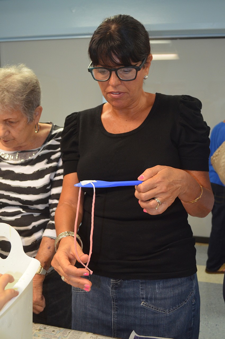 Sabrina Silverberg tries making a candle.