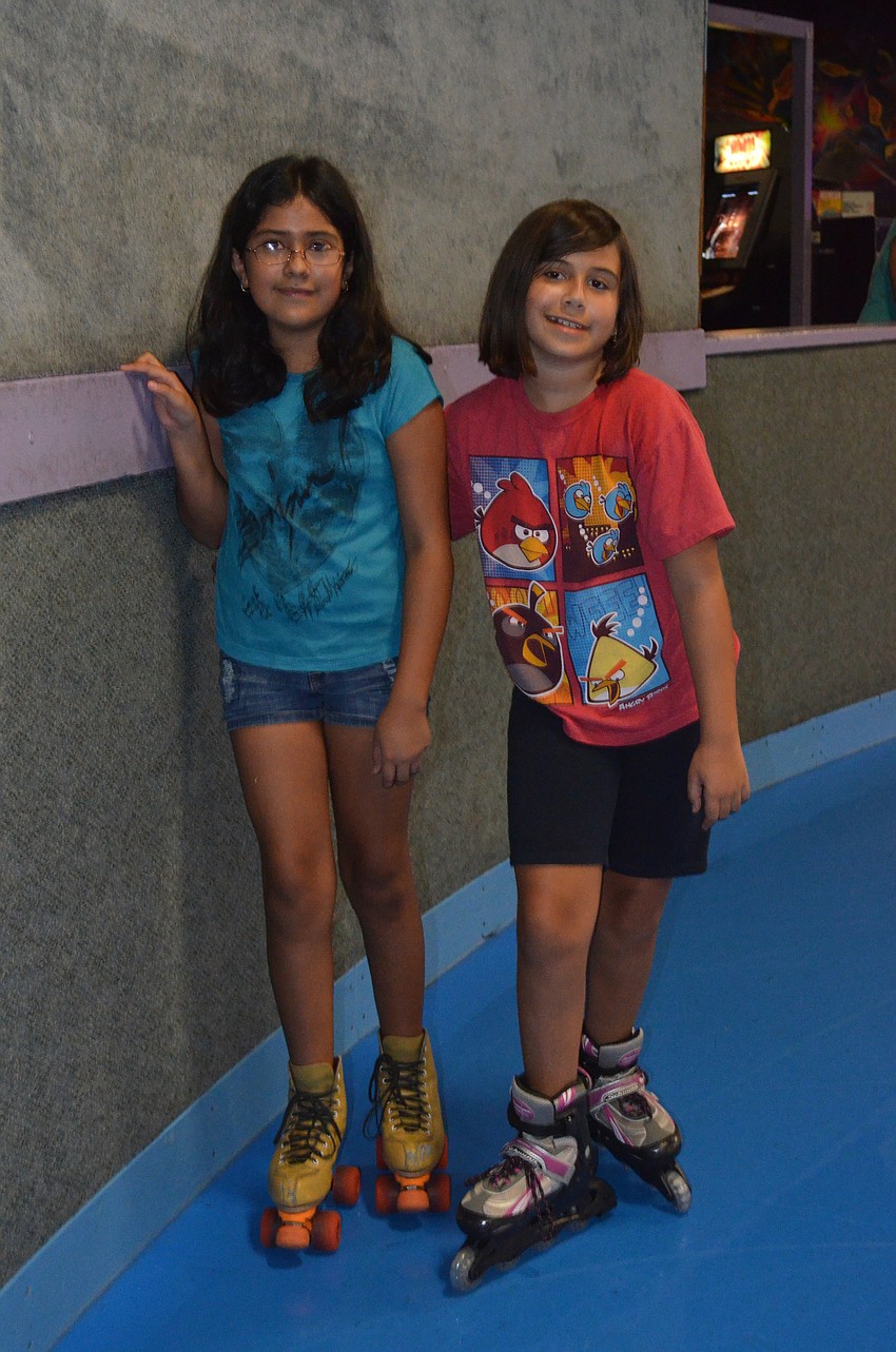 Darlen Montano and Ali Kaiser skate together.