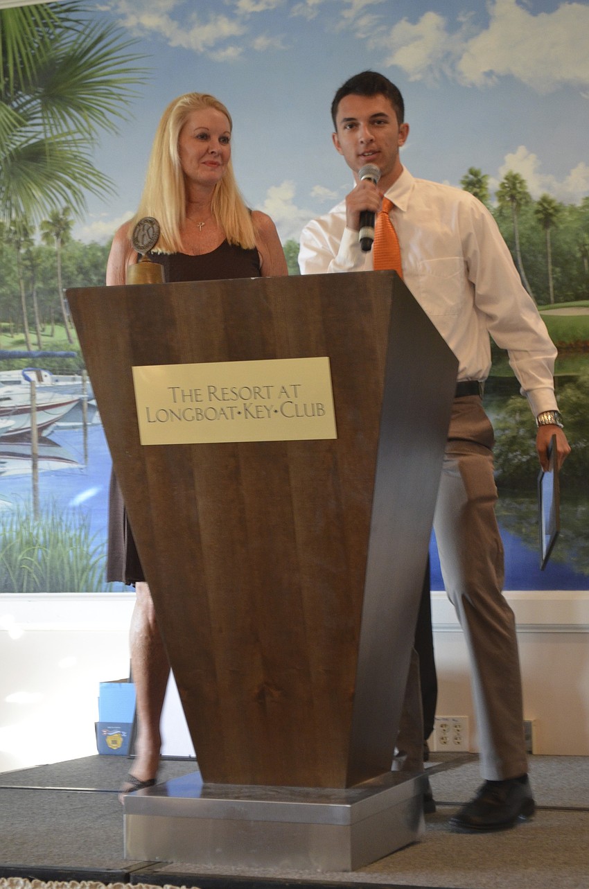 Savannah Schield, University of Florida, is awarded an academic scholarship by Scholarship Committee Chair Susan Philips and Longboat Kiwanis Club President Richard Crawford.