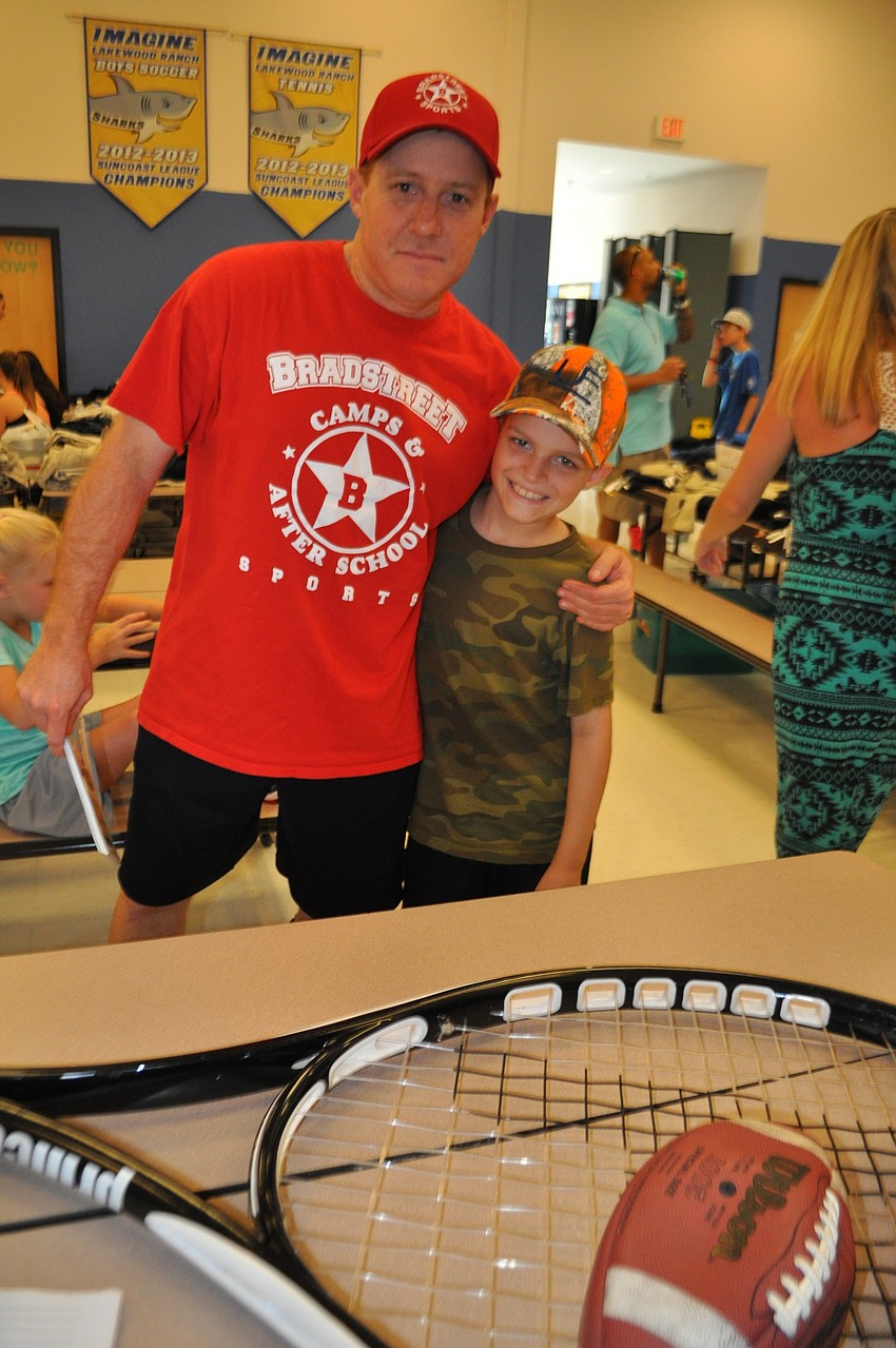 Jason and Drew Bradstreet sign up families for the Bradstreet Camps after-school program.