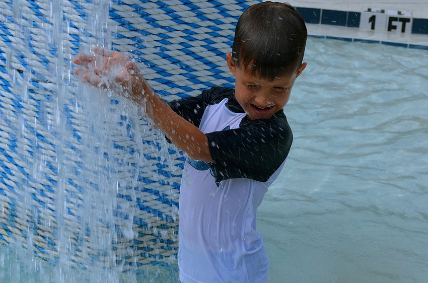 Gabriel Bishop splashes around in the pool.