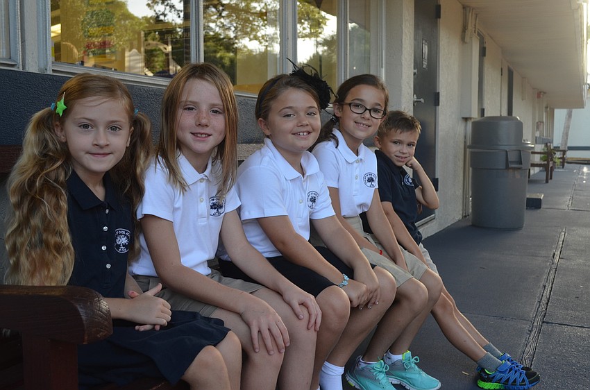 Sophia D., Izzy G. Alex G., Sophia C. and Sequoia M. sit outside of their second grade classroom at ODA.