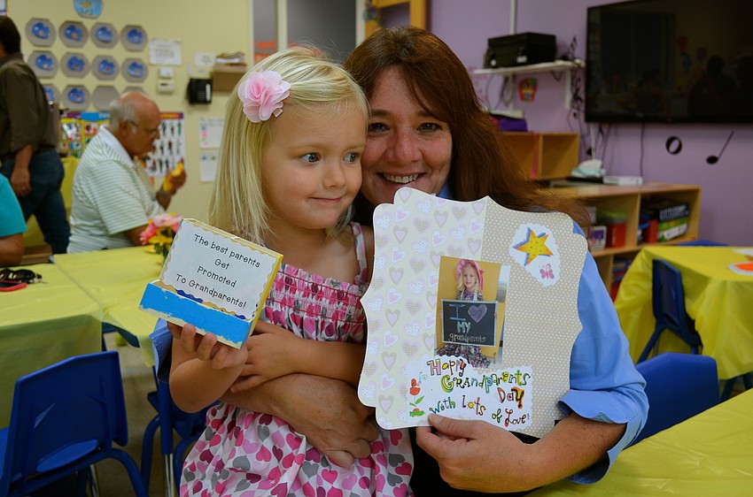 Olivia Drobny and Lynn Reddan show off Grandparents Day crafts.