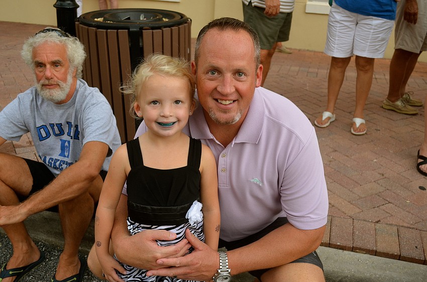 Hayden Bowles sports an ice cream-covered mouth beside her father, Tom.