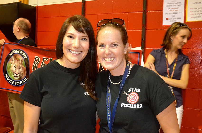 Faculty members Celia Sperotto and Jenn Hall take a breath after dancing.