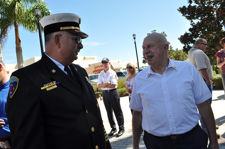 East Manatee Fire Rescue Chief Byron Teates talks with retired Baltimore city fireman Jon Mascari after the ceremony.