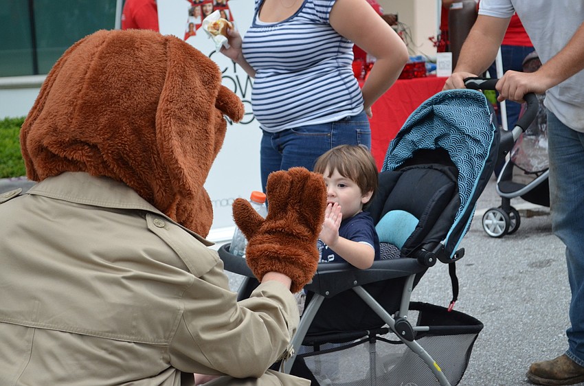 Blake Segura reaches out to hug Scruff McGruff.