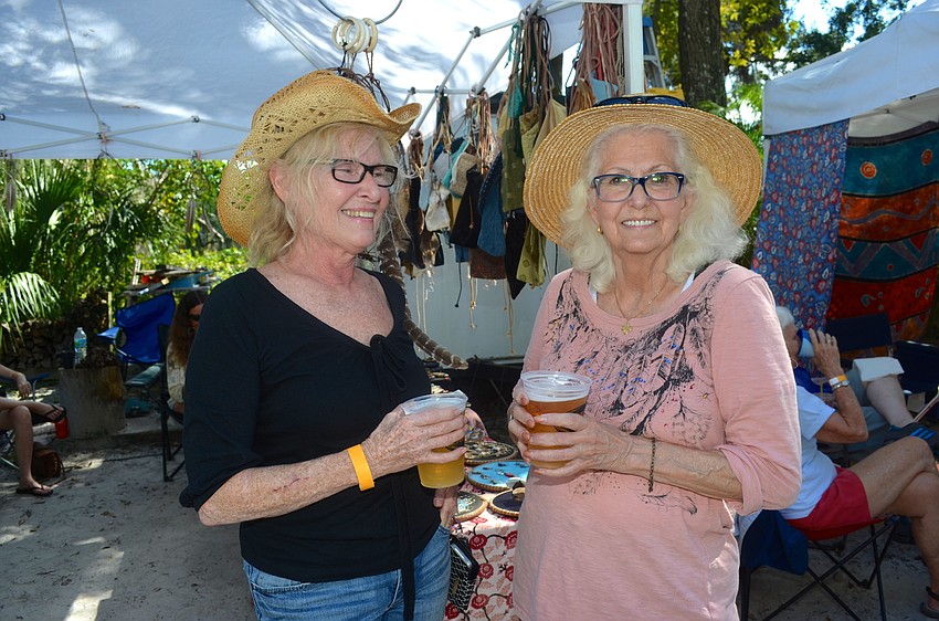 Sandy Gibson and Barb Lee sport matching smiles and hats.