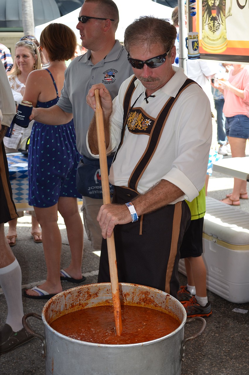 Gary Hixson stirs the chili pot for the Sarasota County Fire Department Station 5 entry.