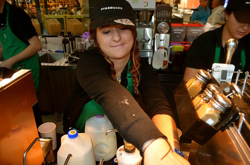 Jess Maydew whips up coffee drinks for the mall's early bird customers.
